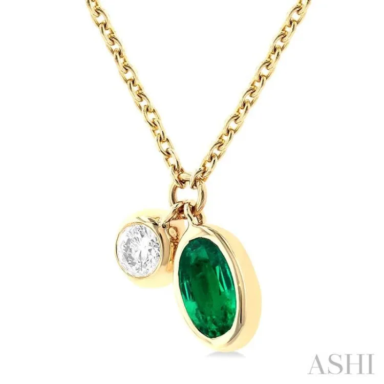 1/50 ctw Oval Cut 6X4MM Emerald and Bezel Set Round Cut Diamond Precious Necklace in 10K Yellow Gold